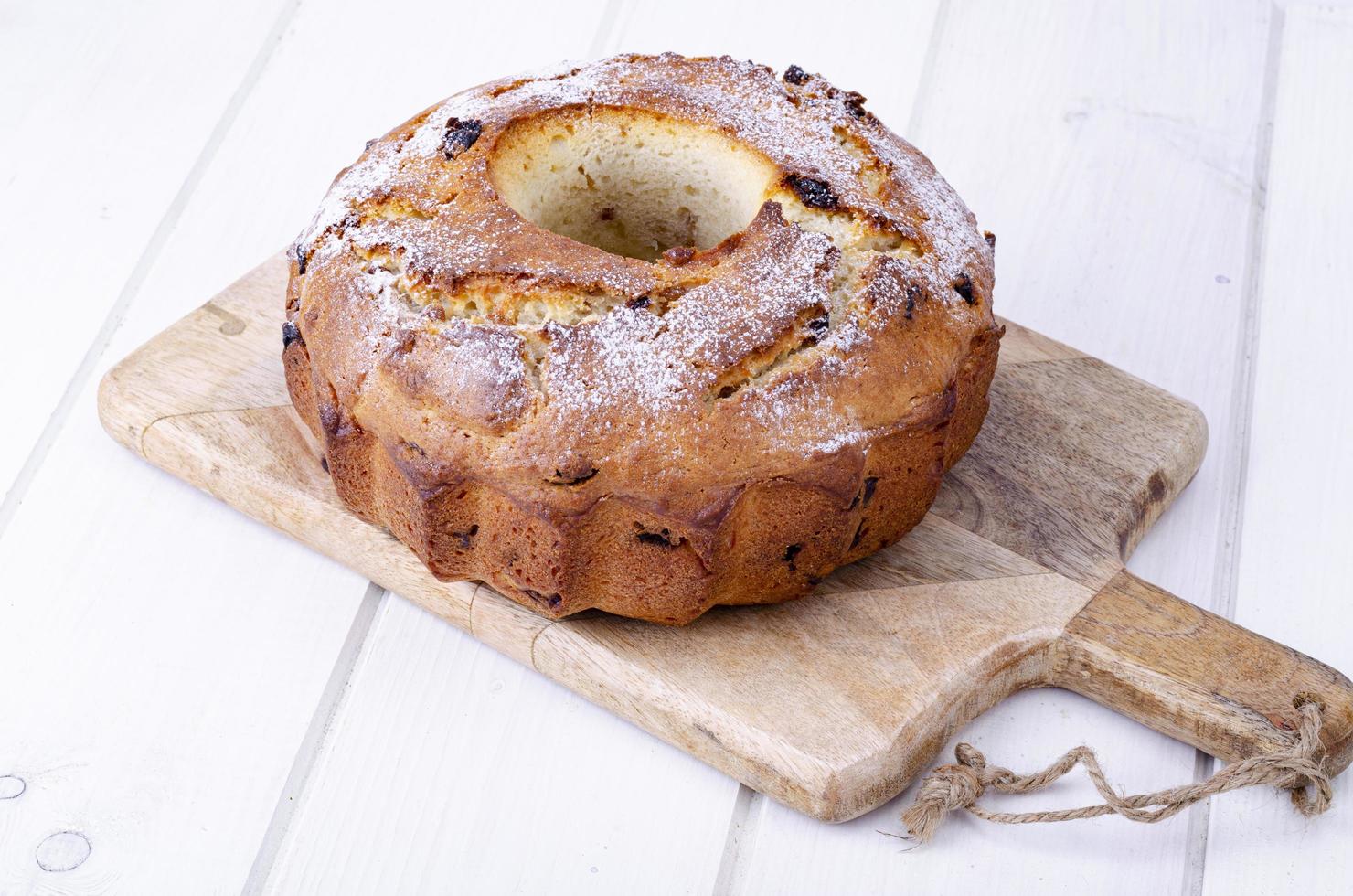 Sweet homemade muffin with raisins on wooden plank. Studio Photo