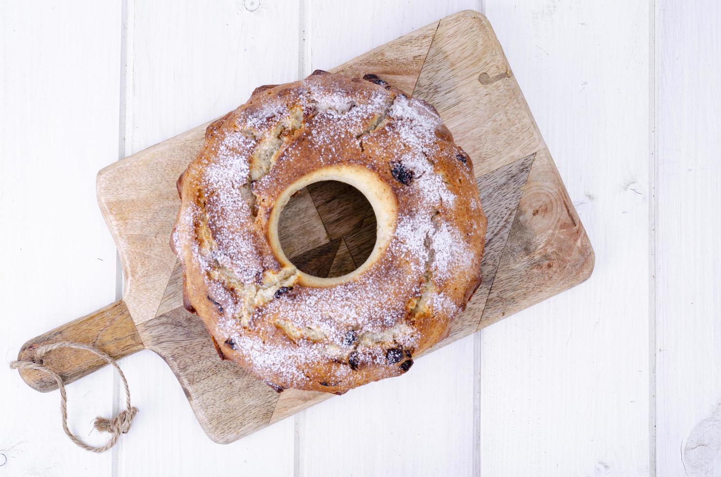Sweet homemade muffin with raisins on wooden plank. Studio Photo