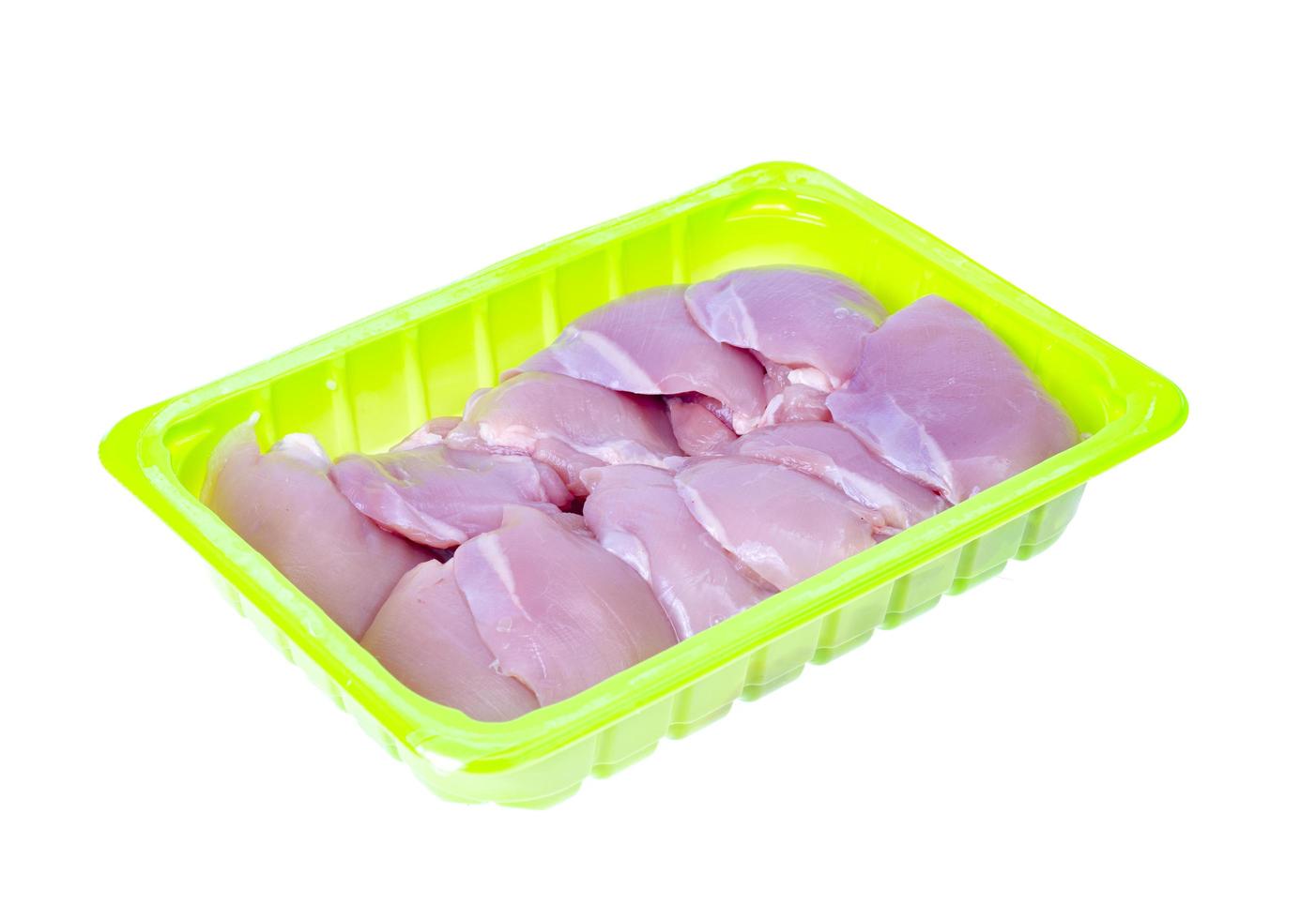 Fresh raw pink eco chicken fillet for cooking on white plate. Studio Photo