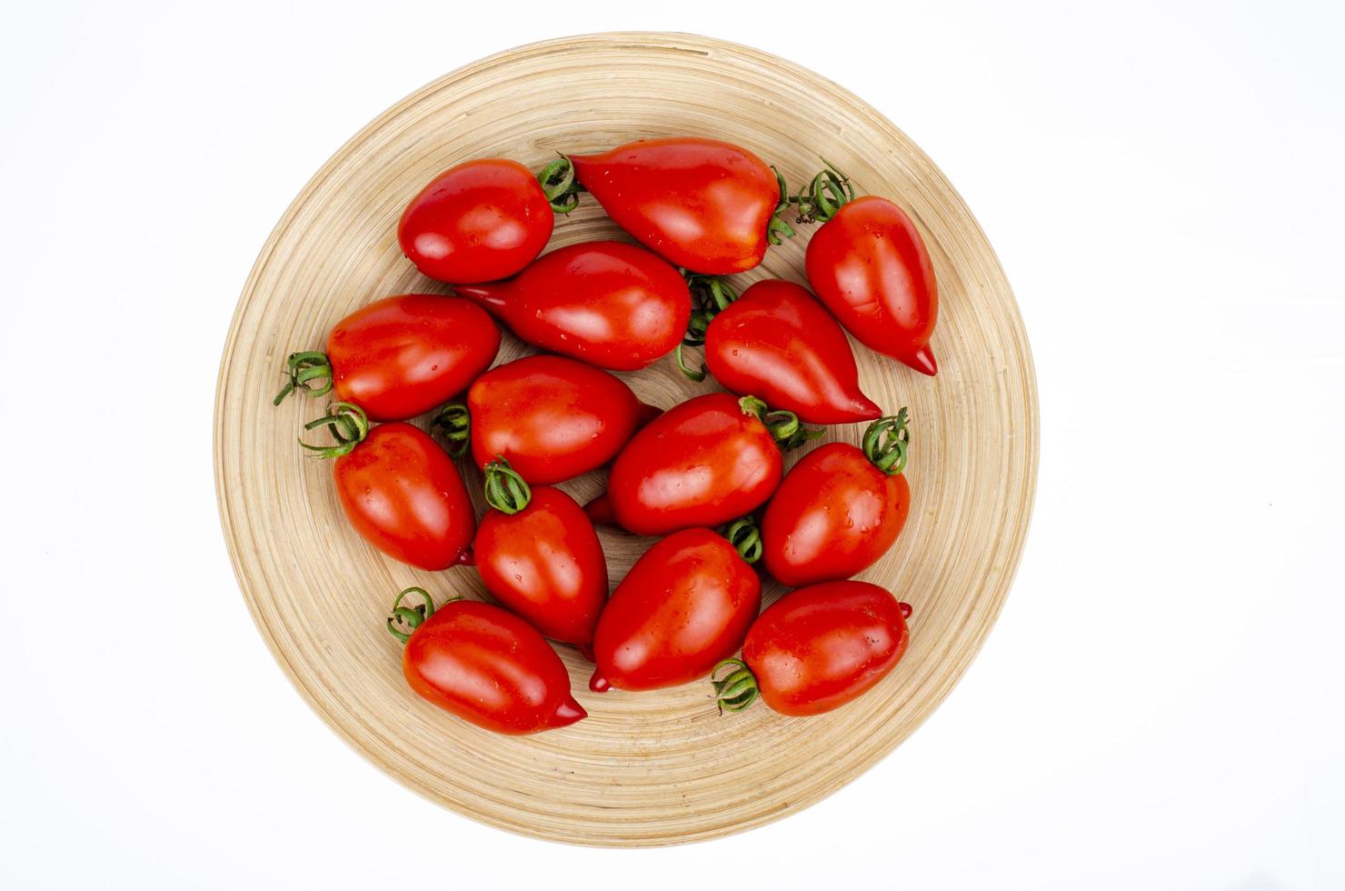 Assorted homemade colorful tomatoes different shapes on wooden plate. Studio Photo. photo