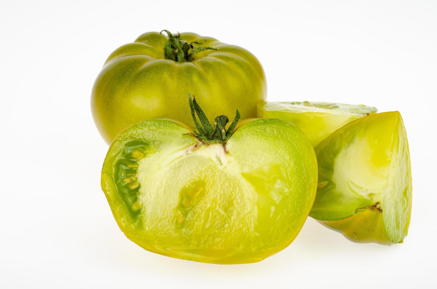 Whole fruit and slices yellow-green color of ripe tomato fruits, isolated on white background. Studio Photo. photo