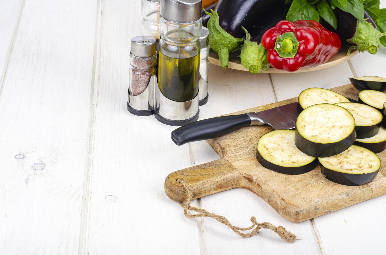 Sliced eggplant slices on wooden board, seasonal vegetables for cooking. Studio Photo