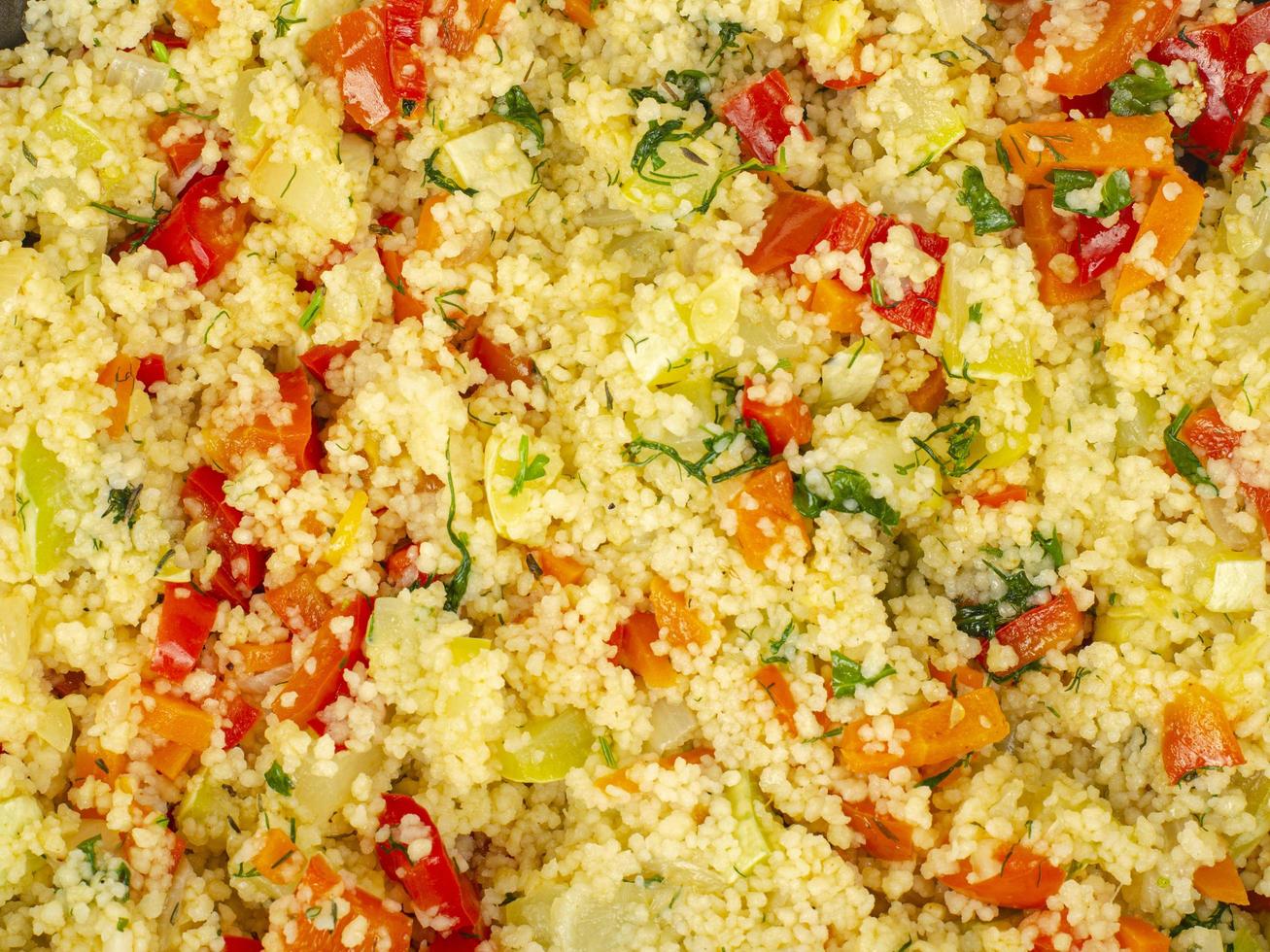 Couscous with vegetables in frying pan. Moroccan cuisine dish. Studio Photo