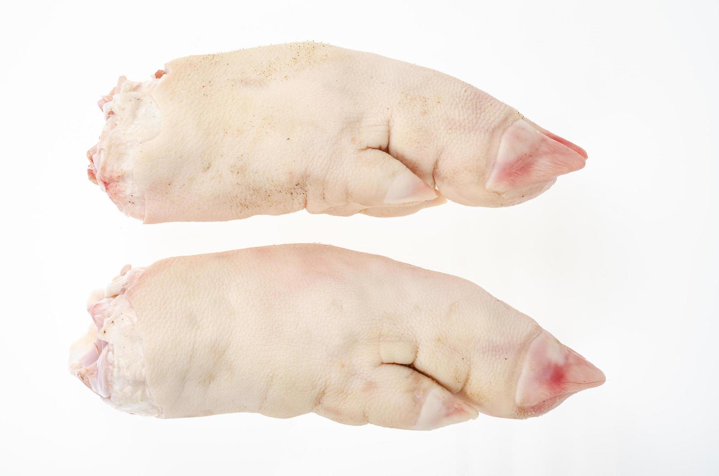 Two raw pork legs for cooking isolated on white background. Studio Photo