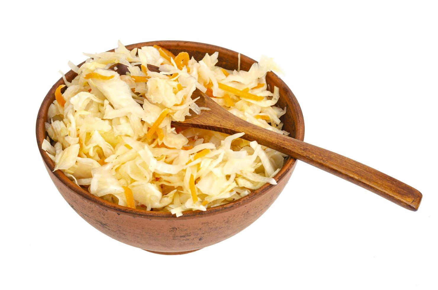 Brown clay bowl with sauerkraut, isolated on white background photo