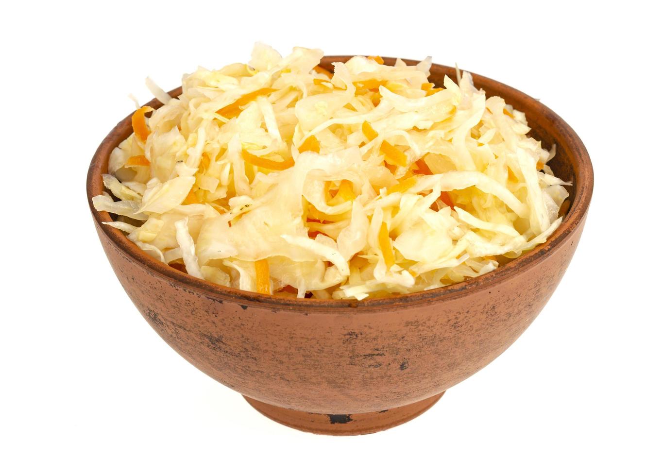 Brown clay bowl with sauerkraut, isolated on white background photo