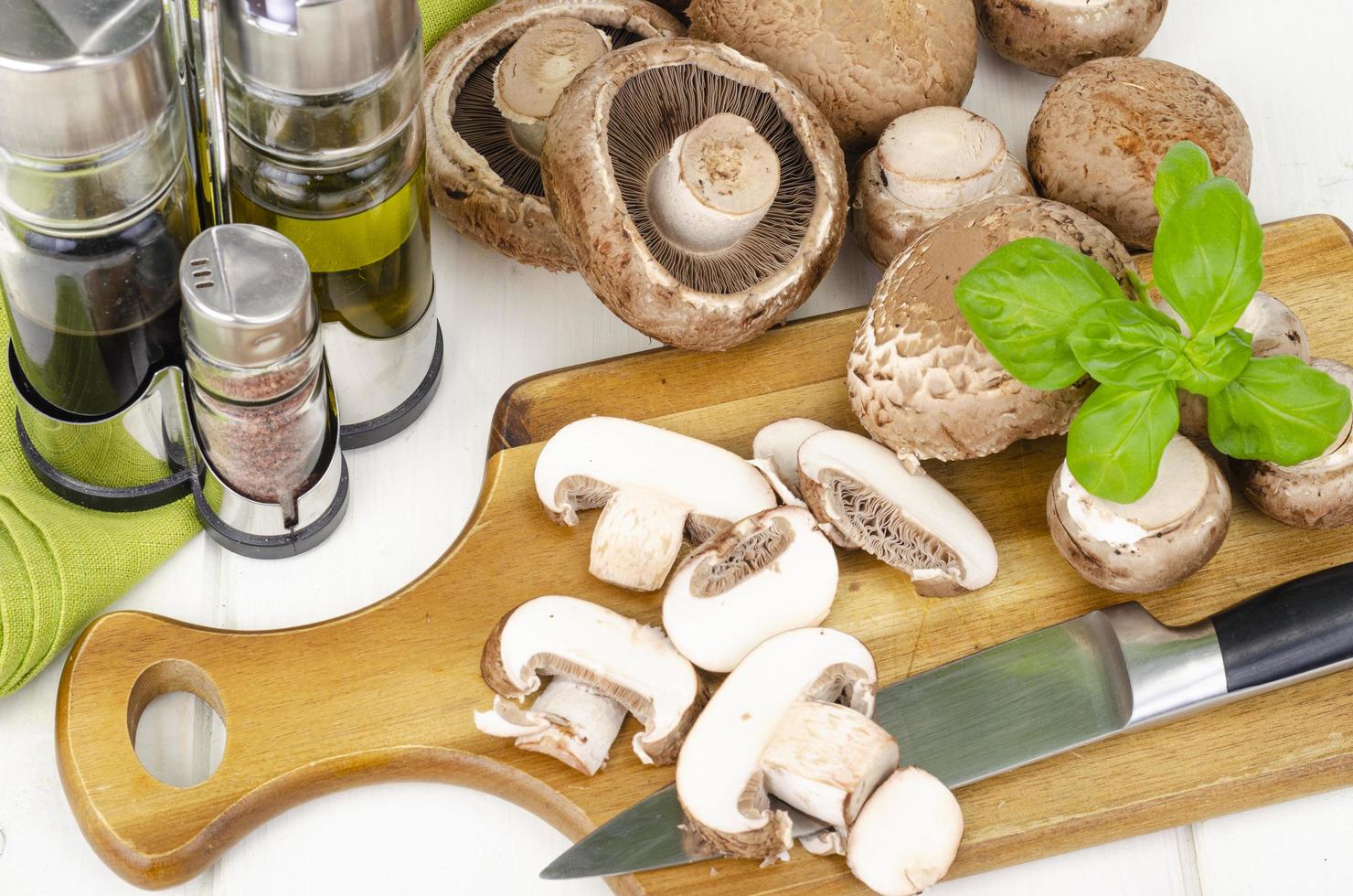 Fresh brown cultivated mushrooms champignons on wooden background. Studio Photo