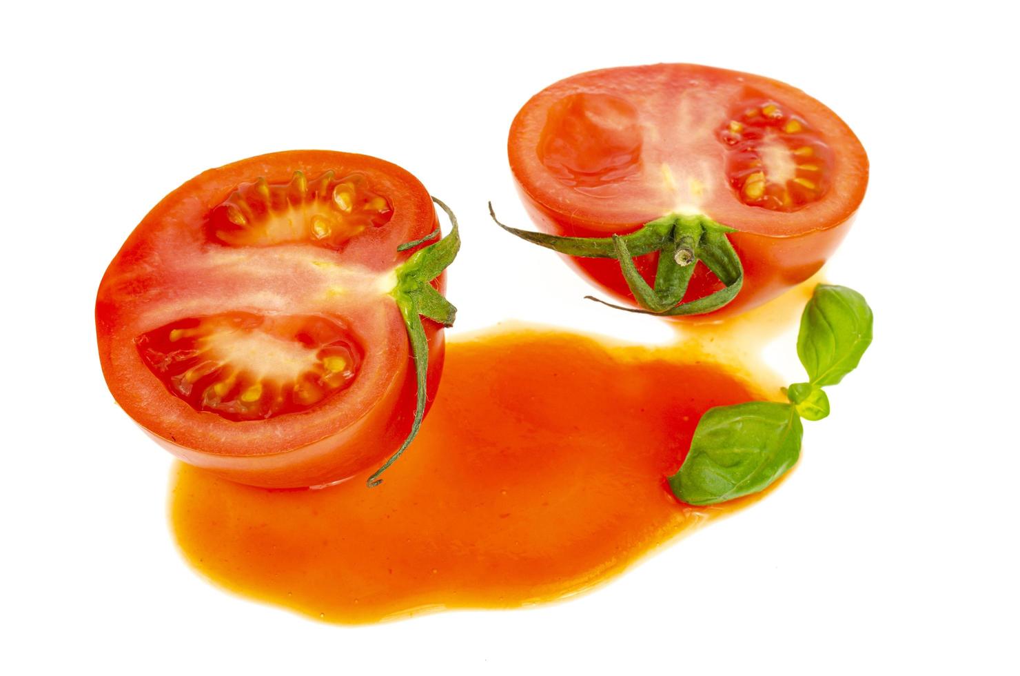 Blot of tomato juice and fresh red tomatoes isolated on white background. photo