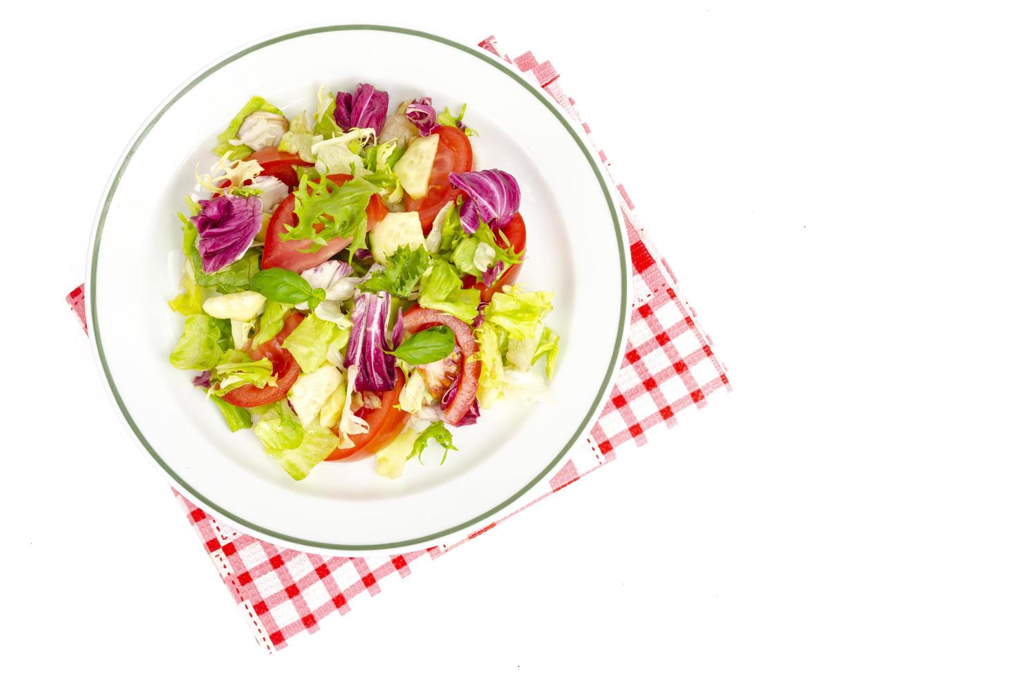 Plate with lettuce, tomatoes, olive oil. Vegetarian menu. photo
