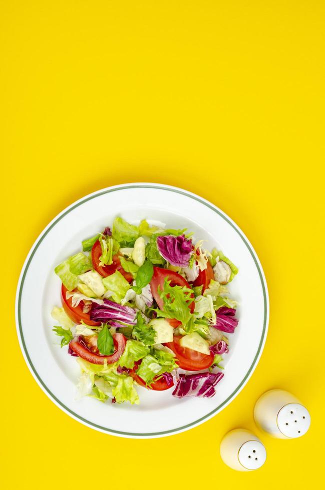 Light dietary vegetarian salad in plate on bright background. Healthy lifestyle concept photo