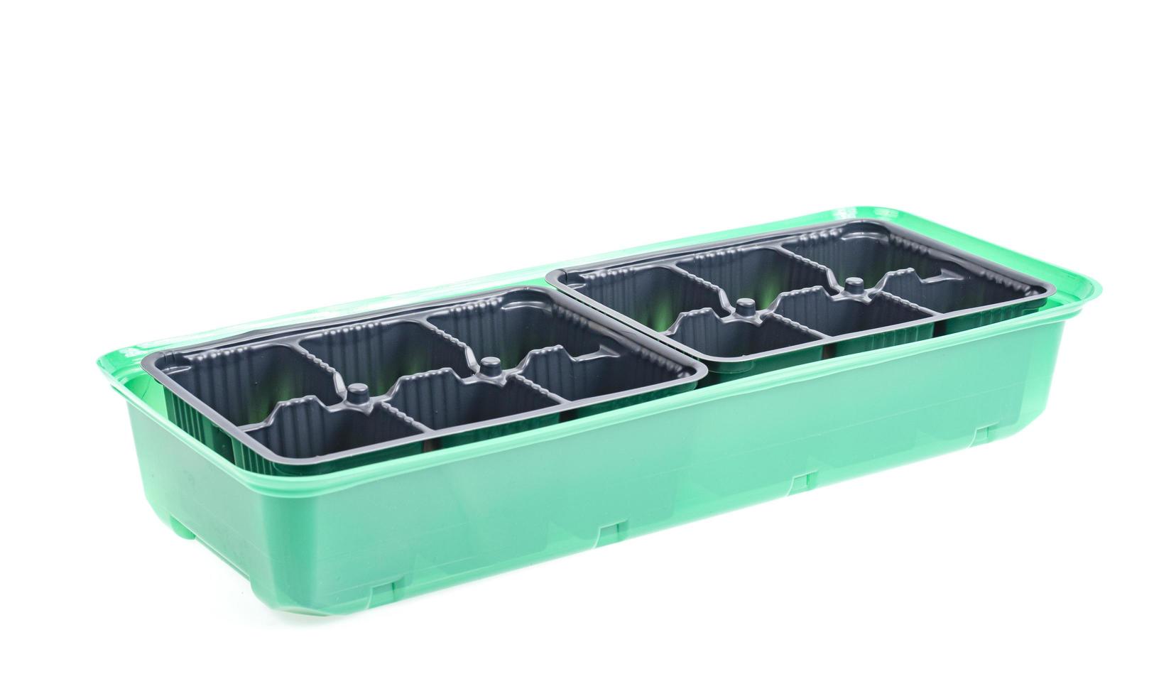 Black plastic cassettes for growing plant seedlings on white background. photo