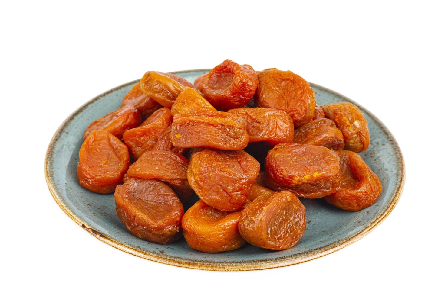 Orange fruits of dried apricot on white background. photo