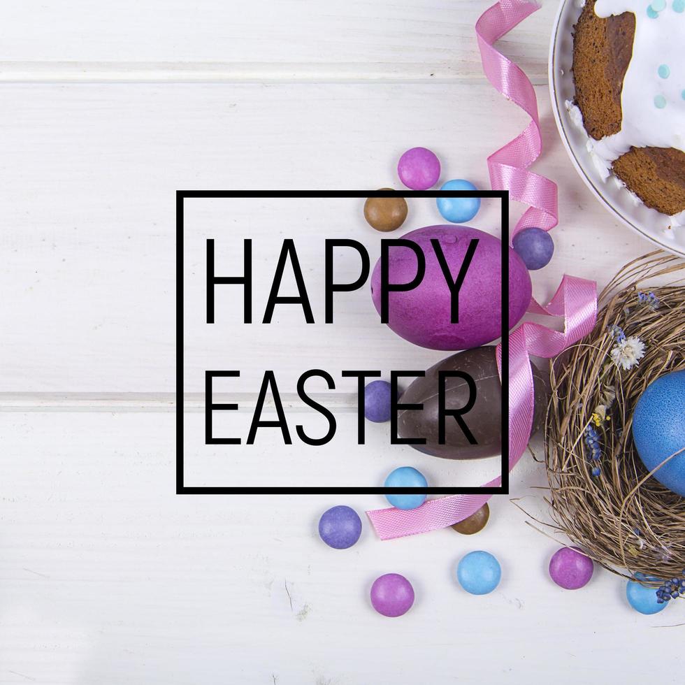 Colorful background with Easter eggs on white wooden board background. Happy Easter concept. Can be used as poster, background, holiday card. photo