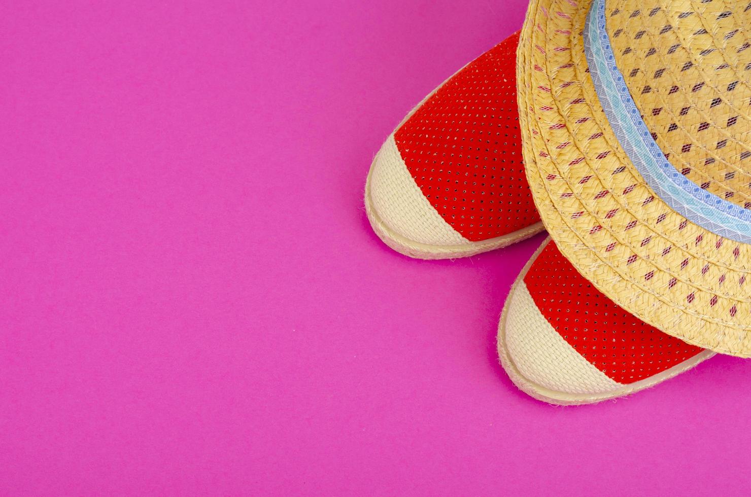 Summer composition of hats and shoes on bright background photo