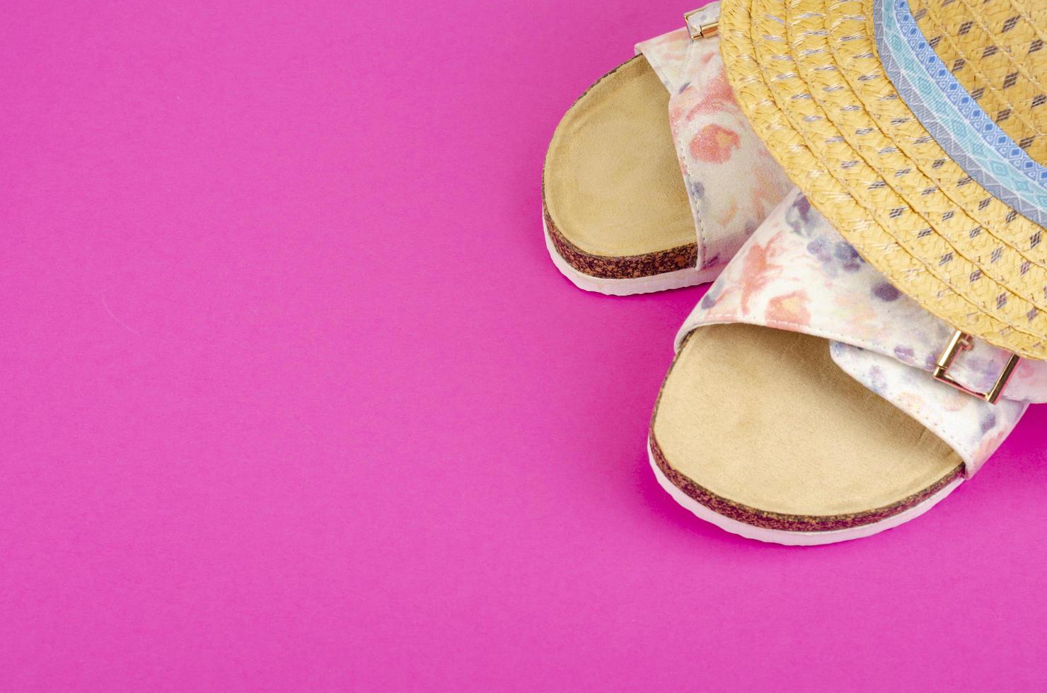 Summer composition of hats and shoes on bright background photo