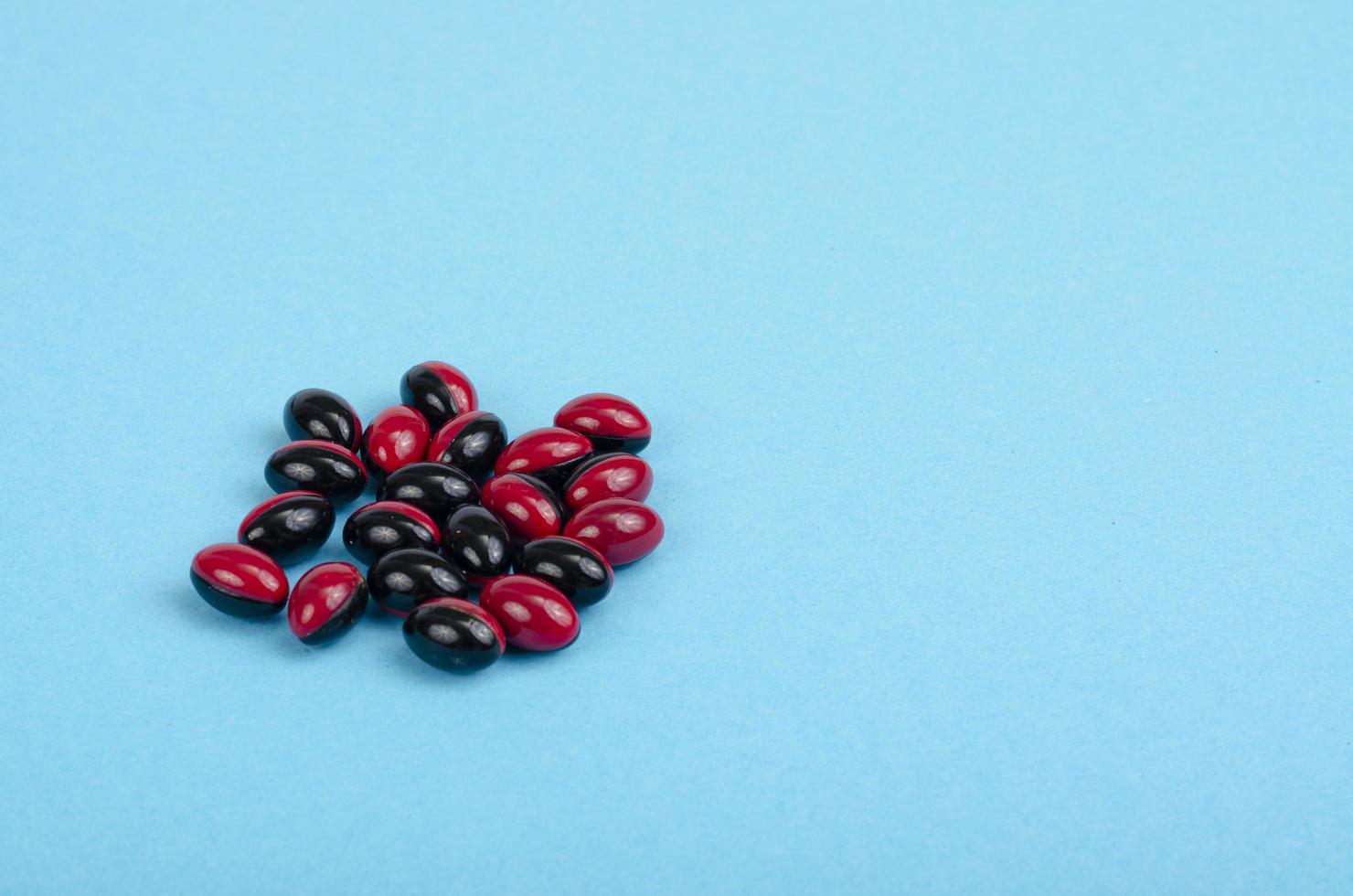 Bicolor medical pills on bright background. Photo