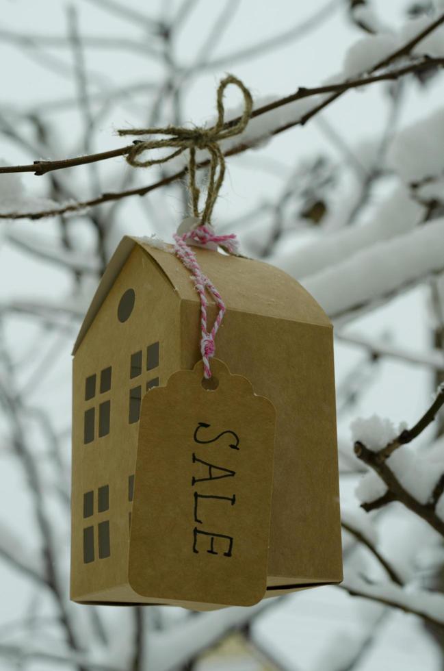 Real estate sale concept, paper model of residential building. photo