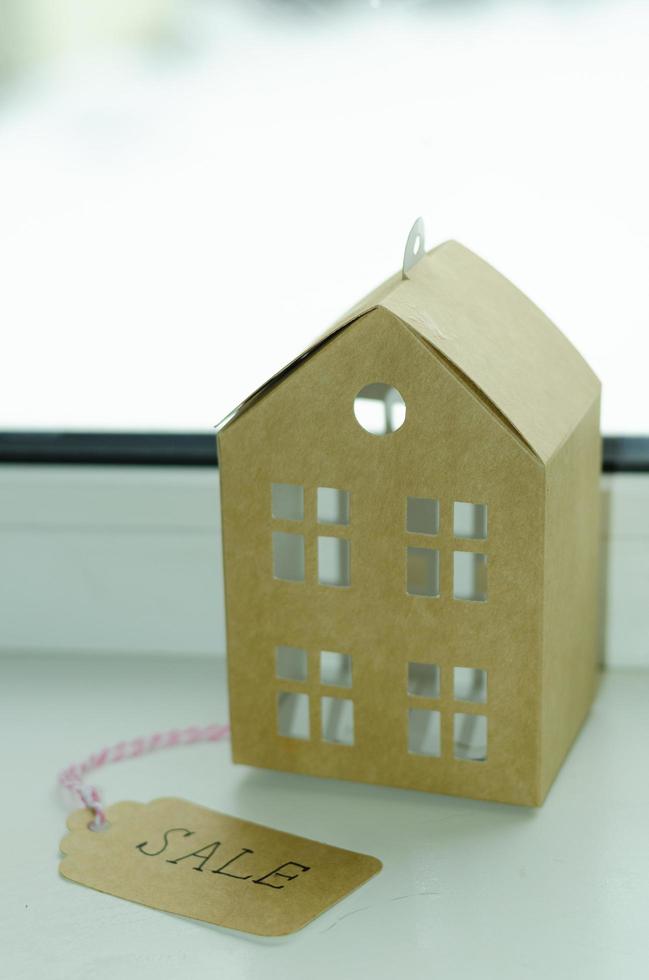 Real estate sale concept, paper model of residential building. photo
