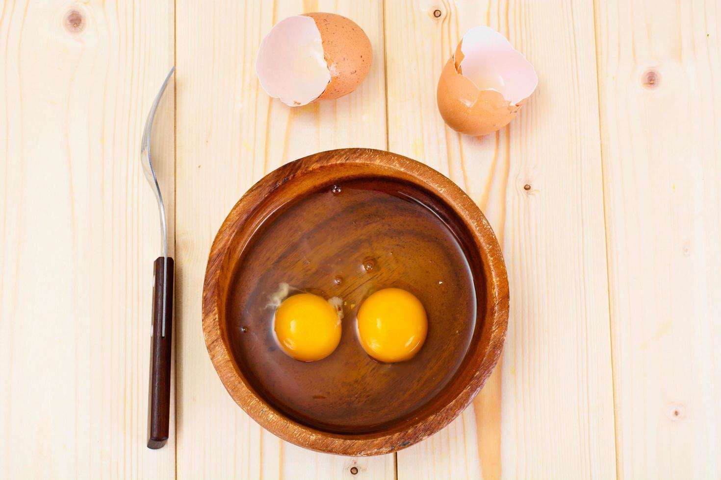 Raw Eggs on Wood Plate photo
