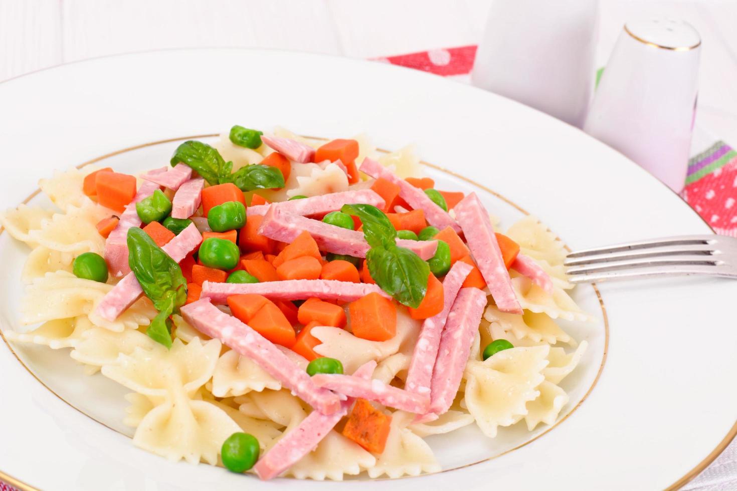 Pasta Bow with Diced Carrots, Salami and Green Peas photo