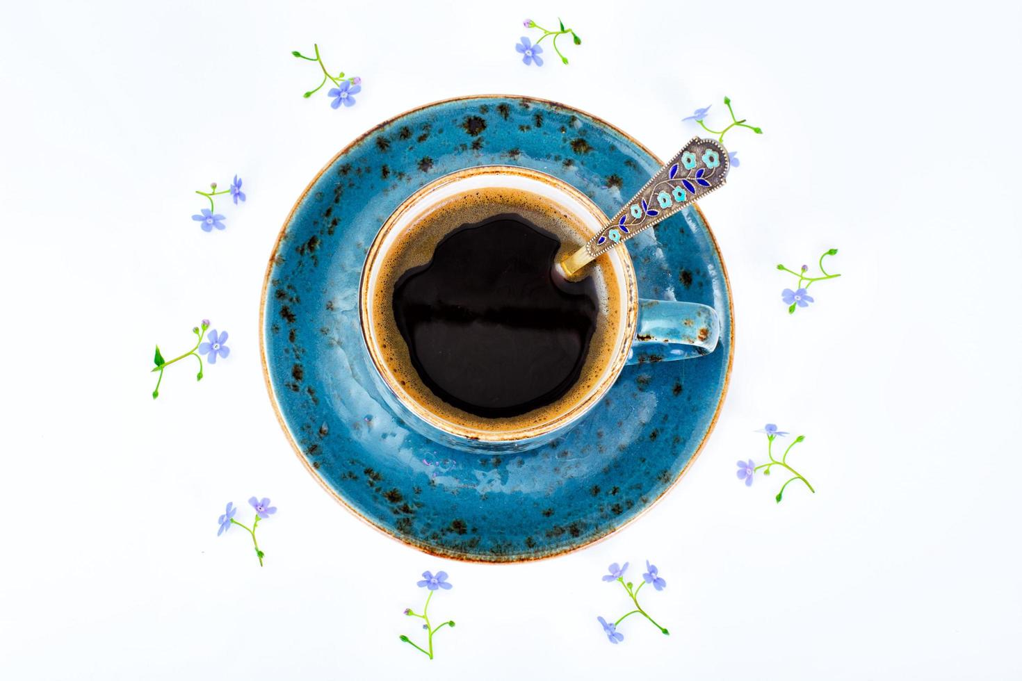 Coffee  in a blue retro cup with Flowers photo