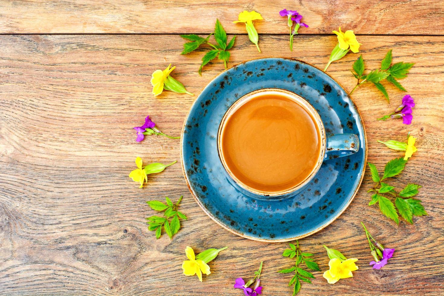 Coffee  in a blue retro cup with Flowers photo