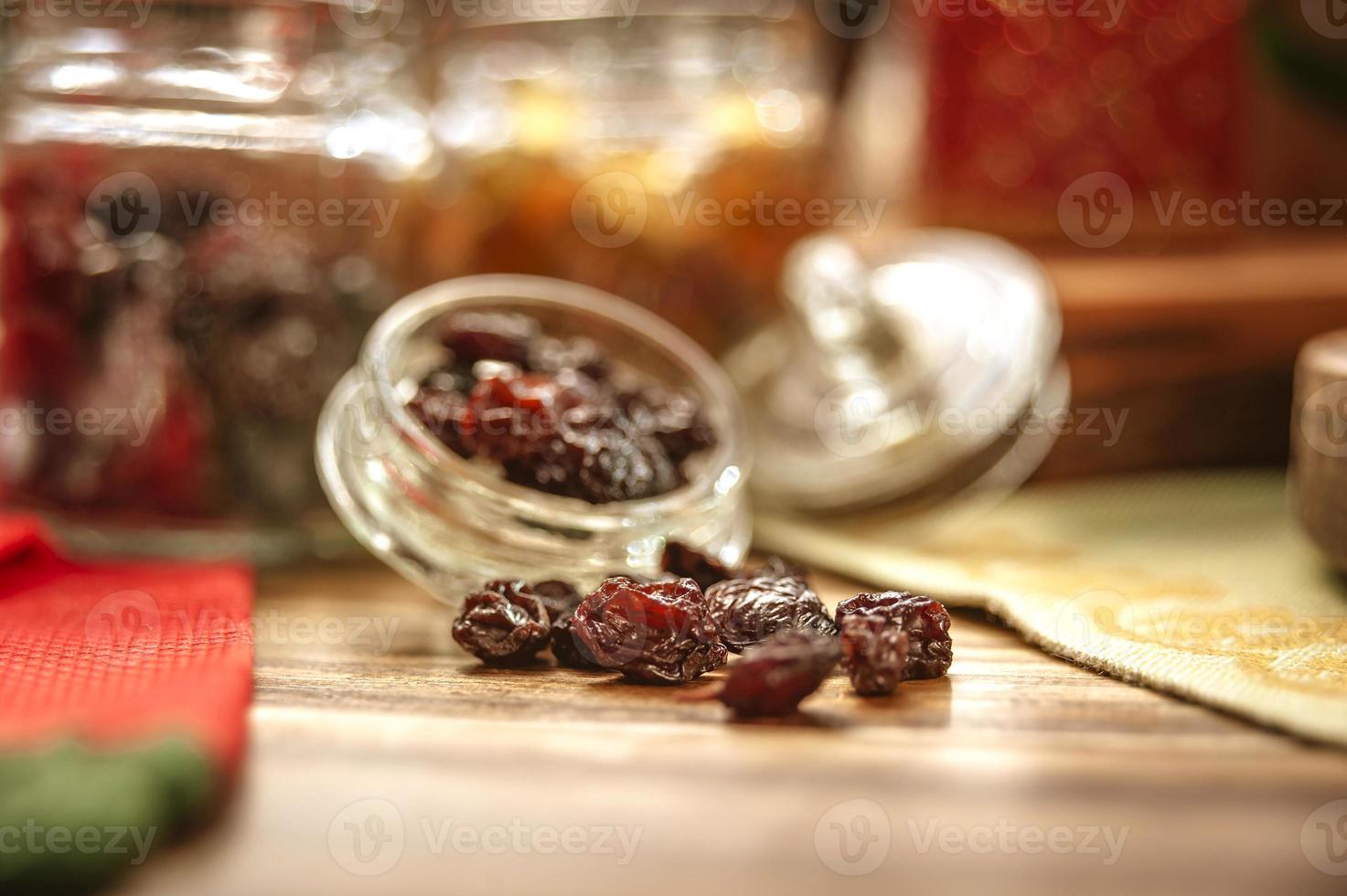 Some raisins on wooden table photo