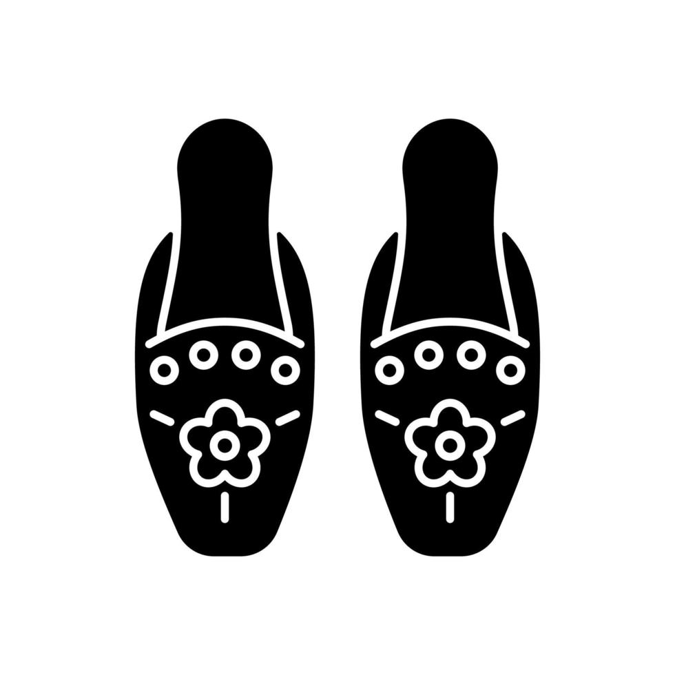 Traditional beadwork black glyph icon. Singaporean beaded slippers. National design. Decorating clothing. Peranakan embroidery. Silhouette symbol on white space. Vector isolated illustration
