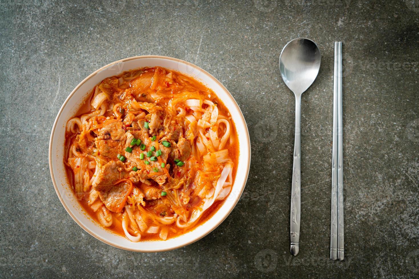 Korean udon ramen noodles with pork in kimchi soup photo