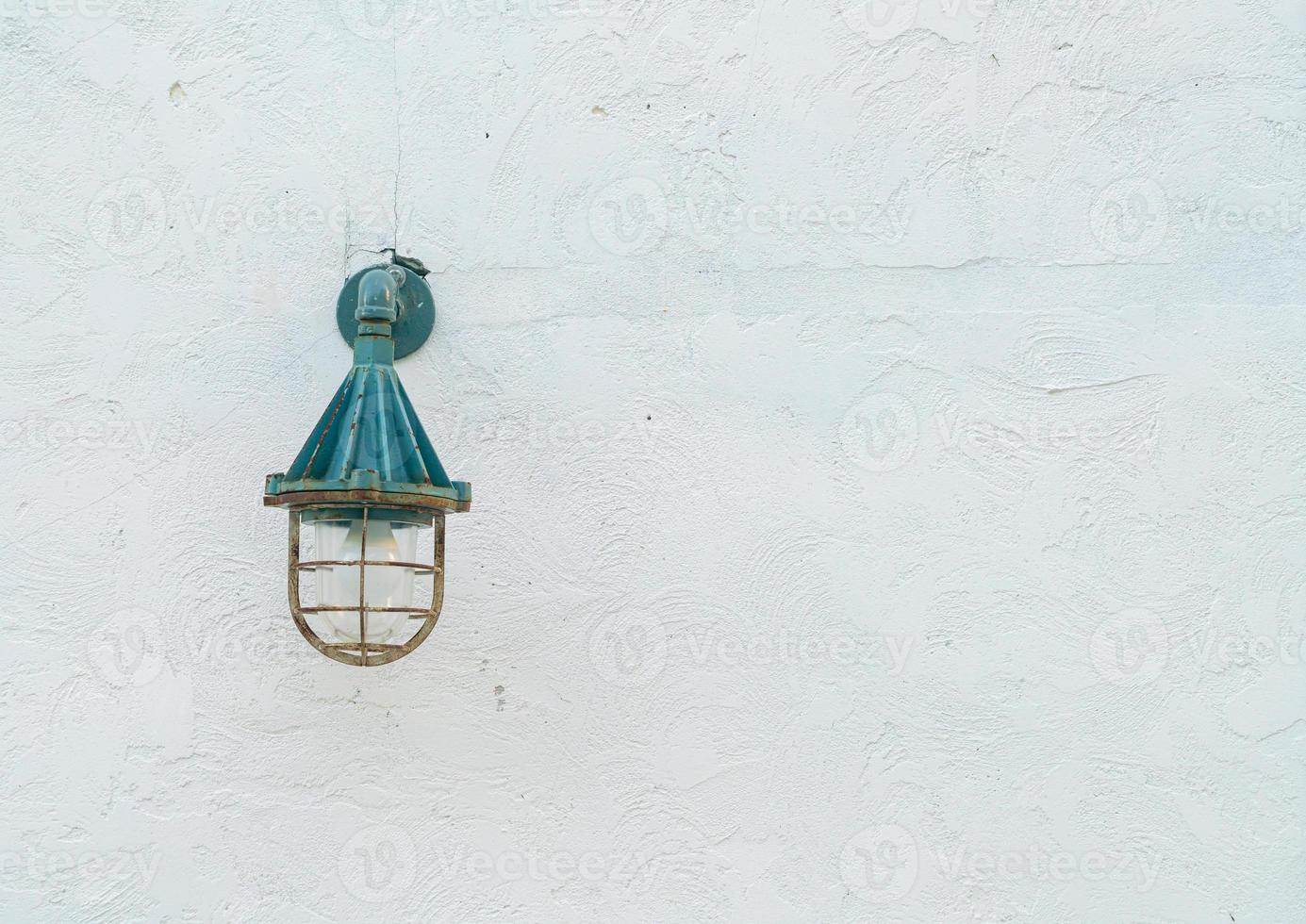 old hanging lamp on white wall photo