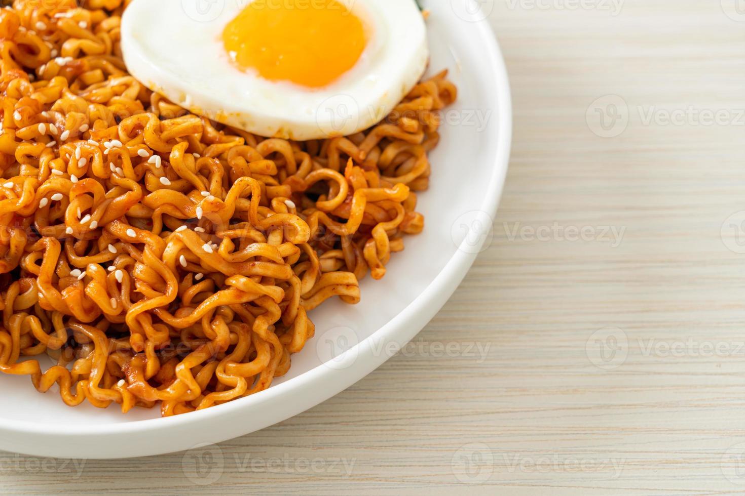 dried Korean spicy instant noodles with fried egg photo