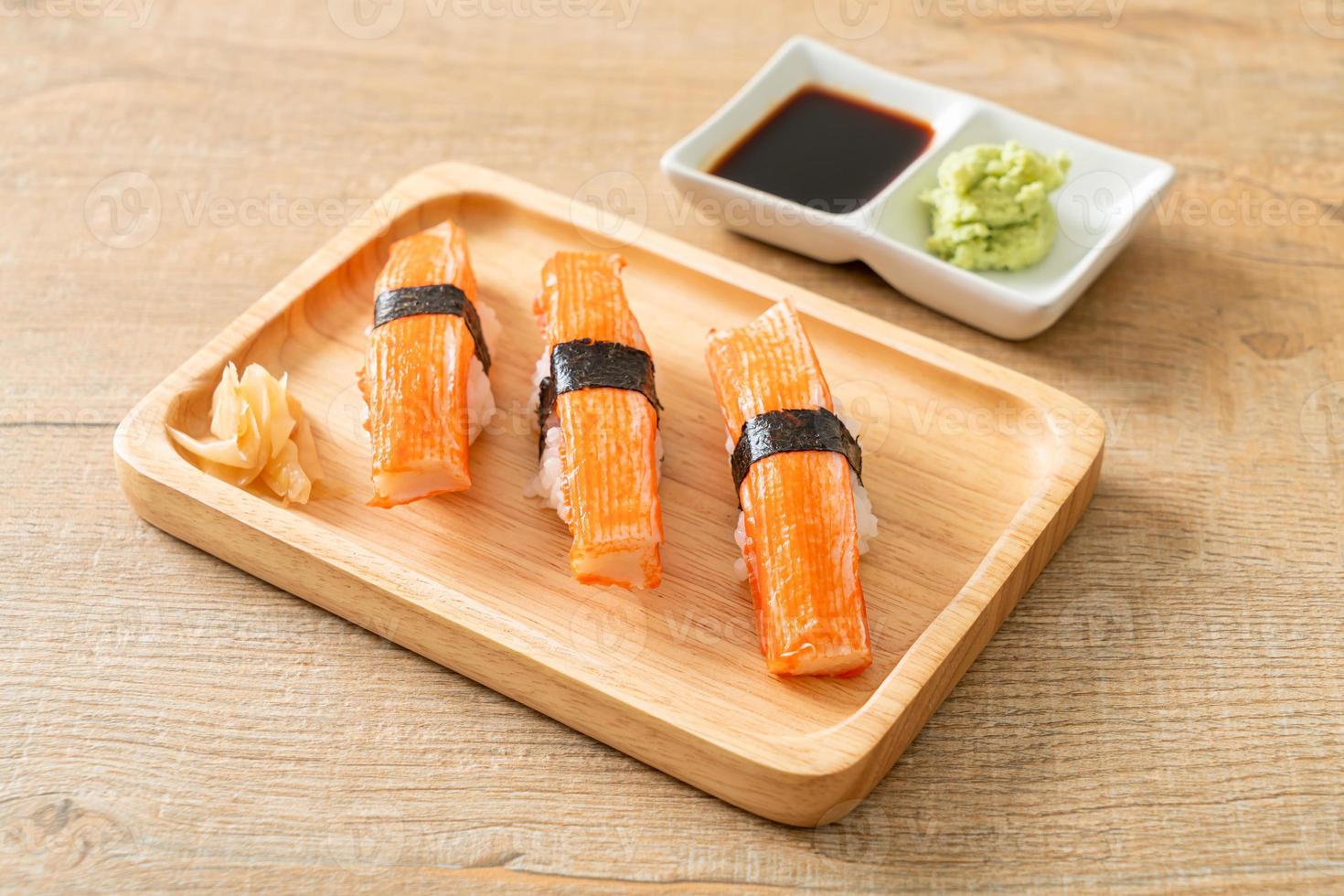 Sushi de palito de cangrejo en placa de madera foto