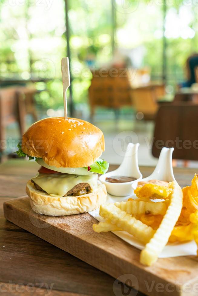 beef burger with cheese and potato chips photo