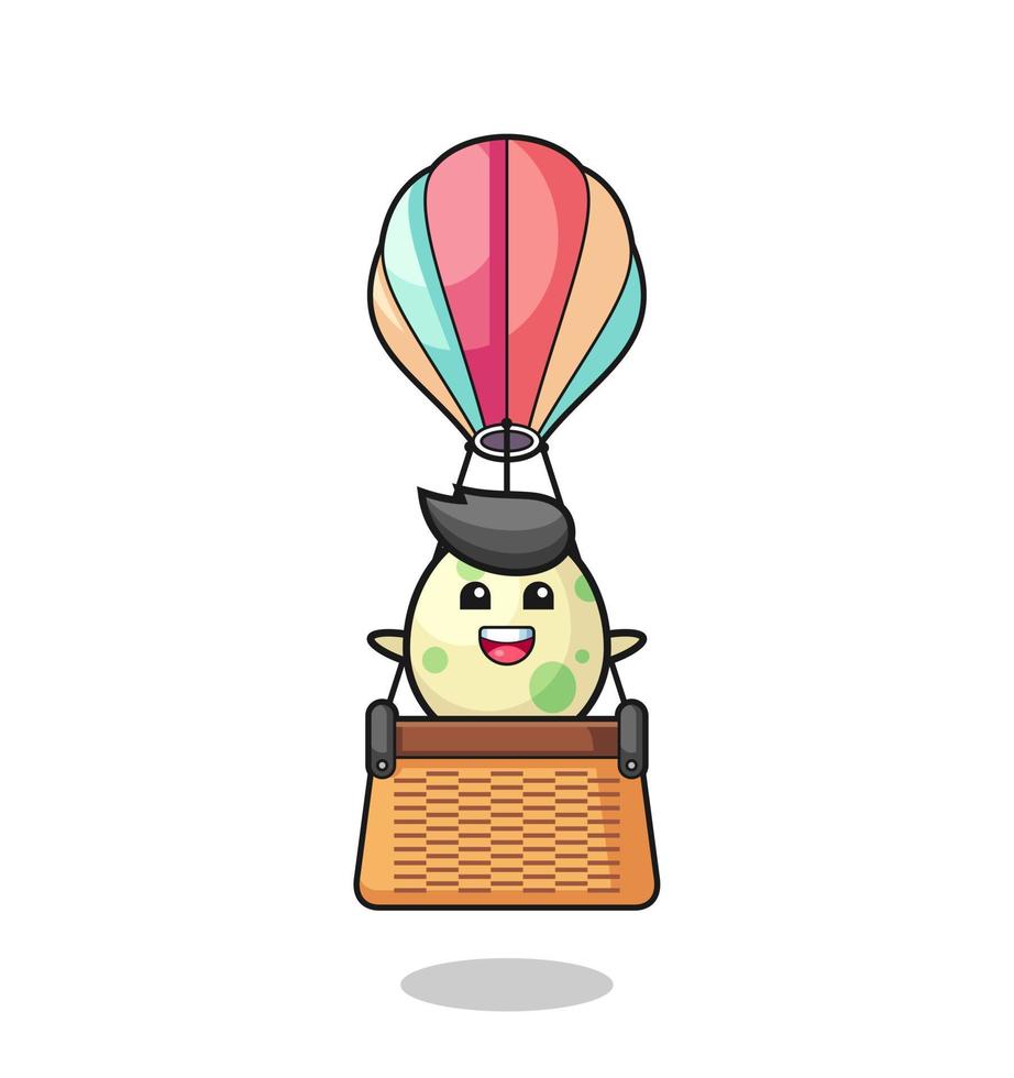 mascota de huevo manchado montando un globo aerostático vector