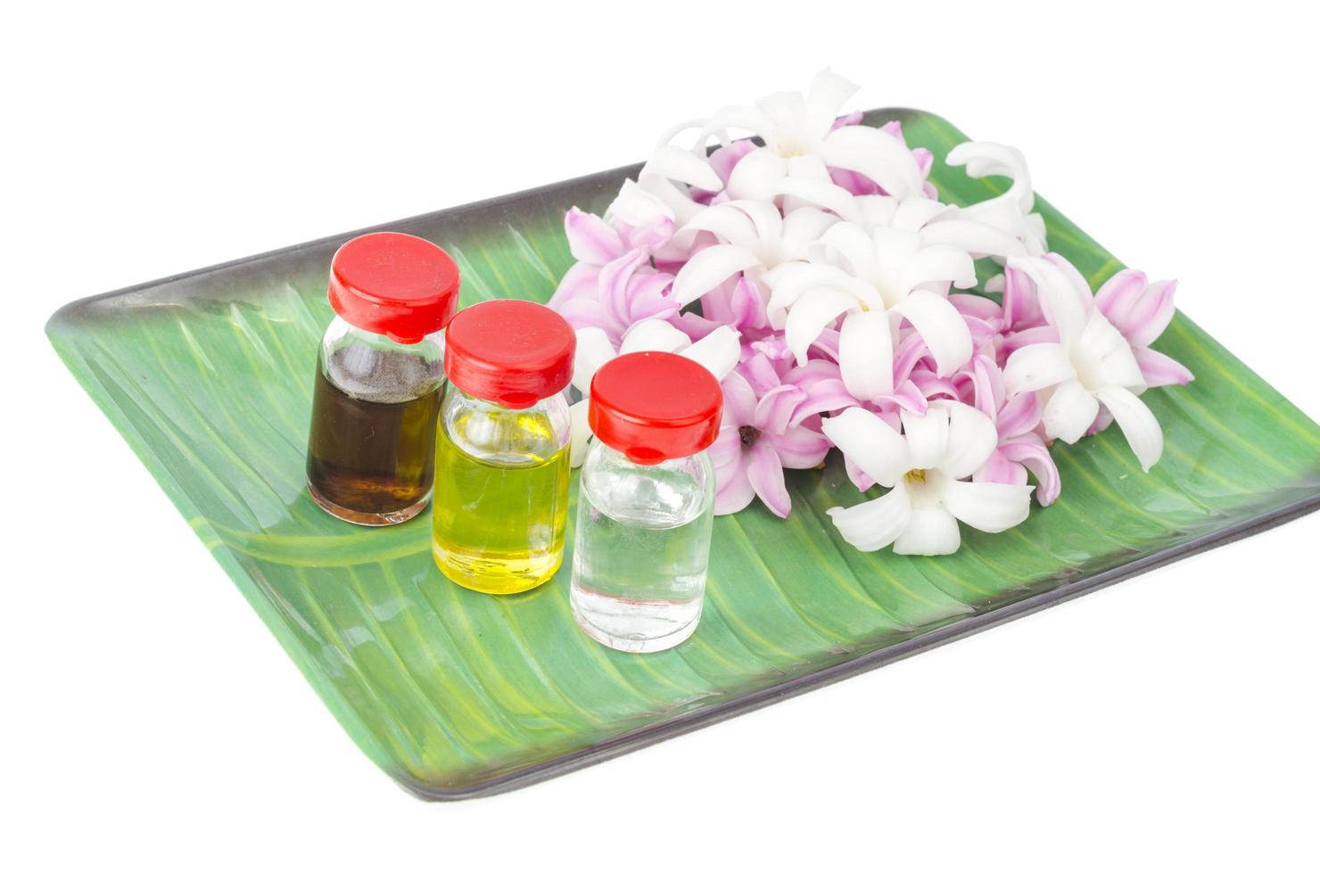 Bottles with floral oil, hyacinth flowers on white bsackground photo