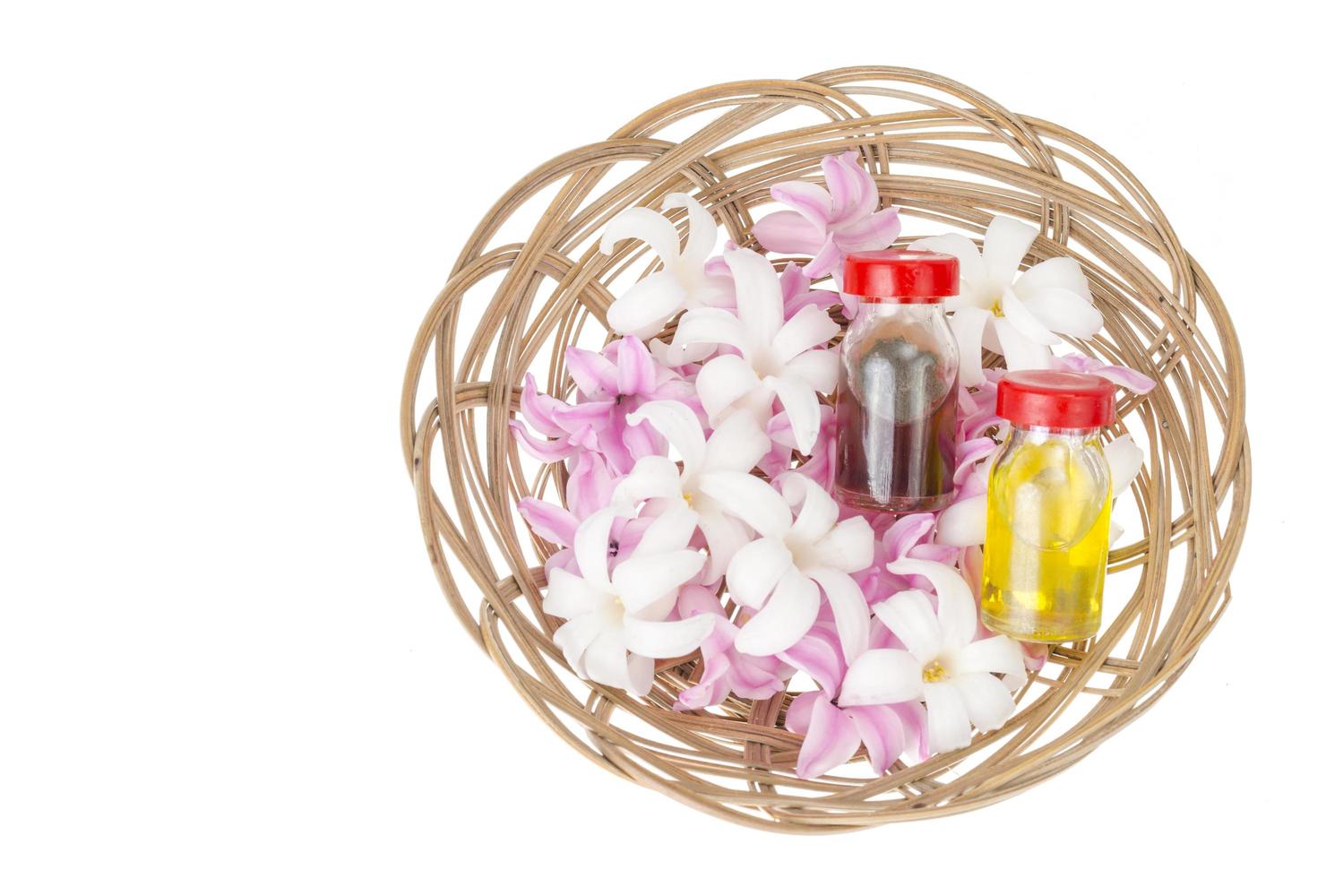 Bottles with floral oil, hyacinth flowers on white bsackground photo