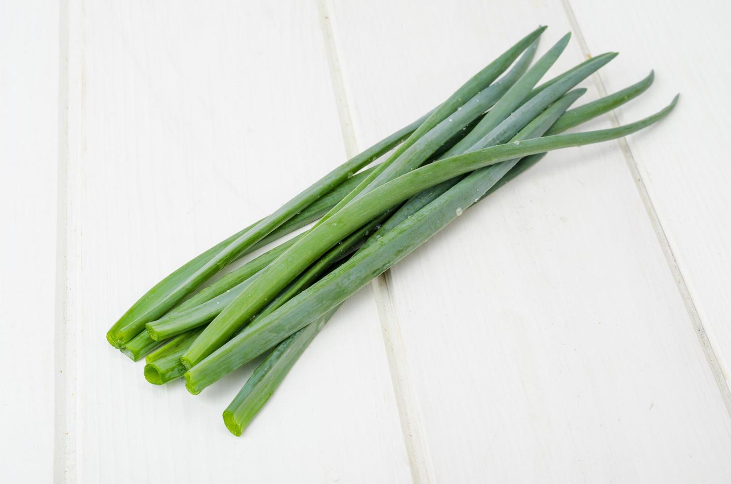 Cutting stalks of green onions, an ingredient in cooking photo