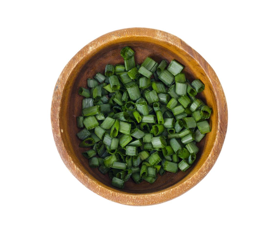 Bowl with slices of chopped green onions for preparing healthy dishes. photo