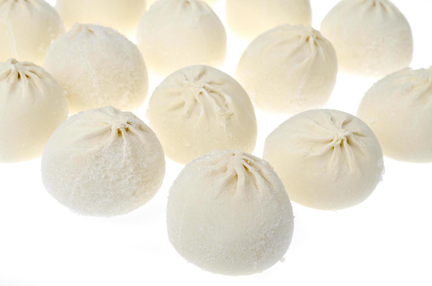 Frozen khinkali with minced meat, isolated on white background photo