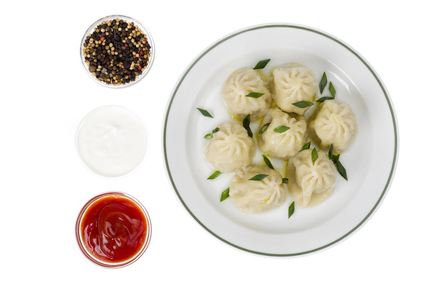 Boiled hot khinkali with meat, spices and ketchup. photo