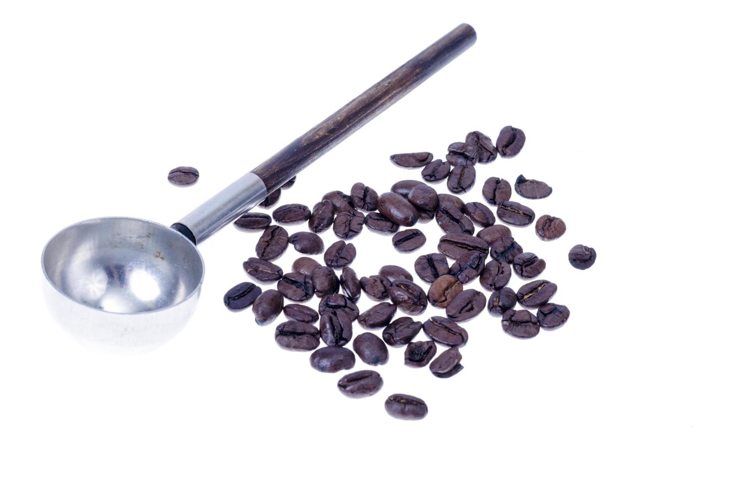 Coffee beans and vintage spoon on white background. Studio Photo