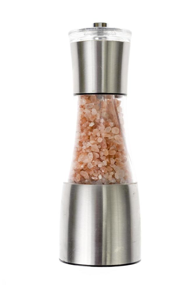 Sea salt in salt shaker, mill on white background. photo