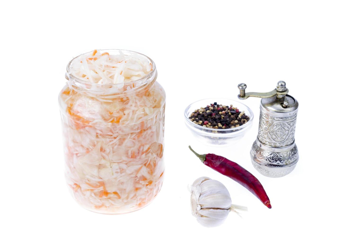 Sauerkraut in glass jar on white. Studio Photo. photo