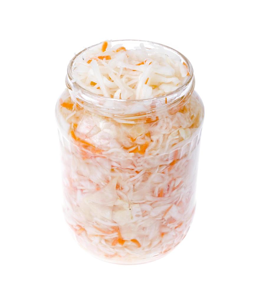 Sauerkraut in glass jar on white. Studio Photo. photo