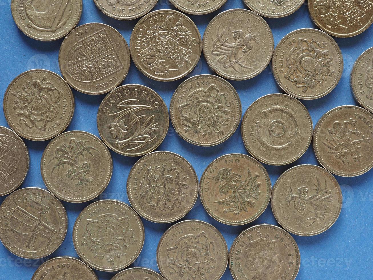 Pound coins, United Kingdom over blue photo