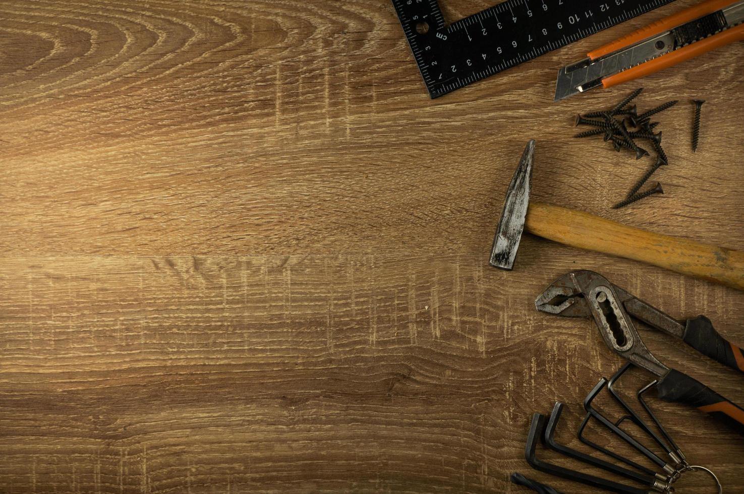 Hand tools lie on a wooden table photo