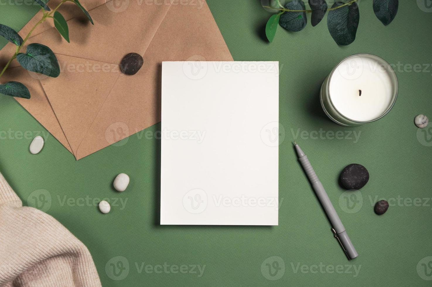 Blank white sheet of paper with an envelope green background photo