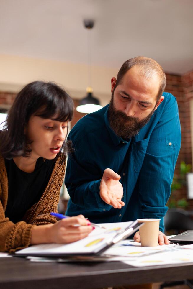 Businessman explaining company strategy to entrepreneur working at marketing project photo