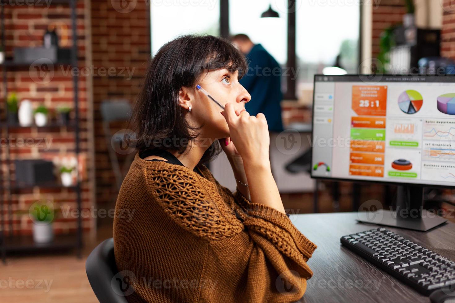 Pensive businesswoman tkinking at marketing presentation working at company strategy photo