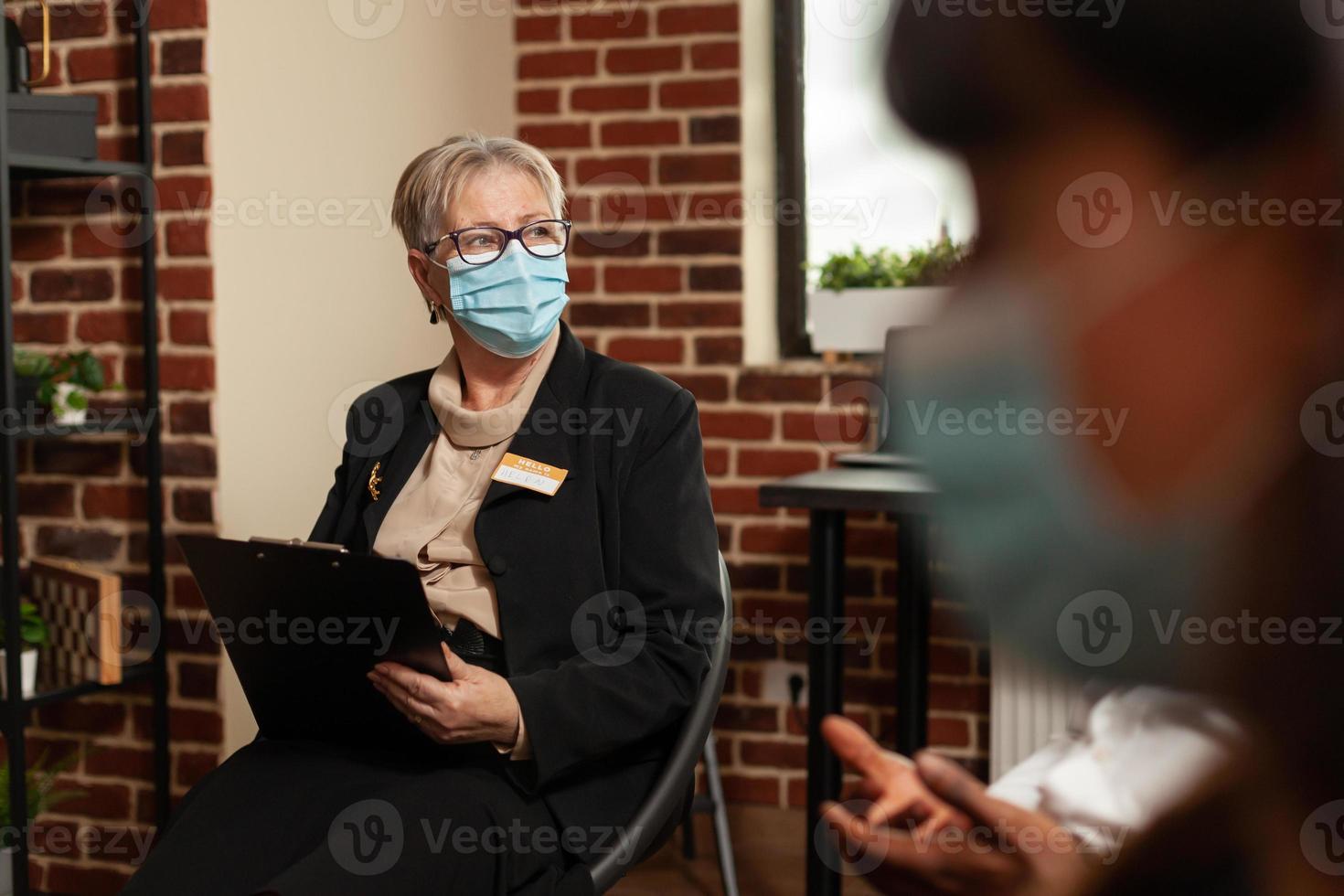 Close up of woman therapist listening to people with addiction at aa meeting photo